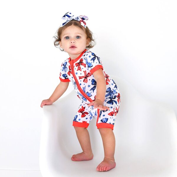 gigi and max eleanor bow clip bow 4th of july hair accessory Baby wearing butterfly-patterned romper and matching bow.