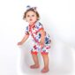 Baby wearing butterfly-patterned romper and matching bow.