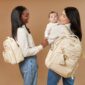 Women with stylish quilted backpacks and baby.