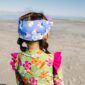 Child in colorful outfit on a beach