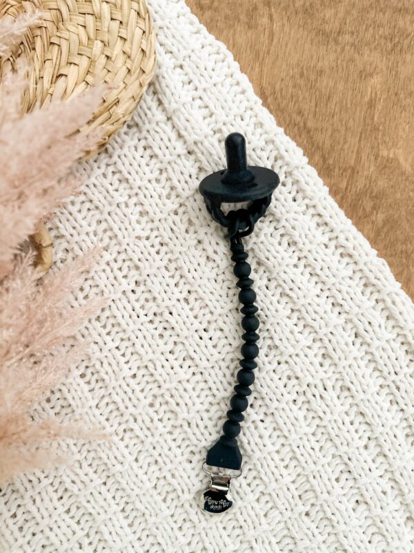 itzy ritzy sweetie soother™ pacifier sets (2 pack): agave + succulent cables Black pacifier clip on knitted white fabric
