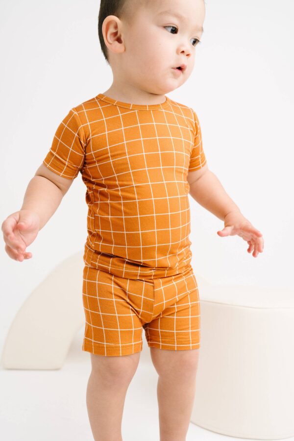 little one shop rust checks bamboo shorts set Toddler wearing orange grid-patterned outfit