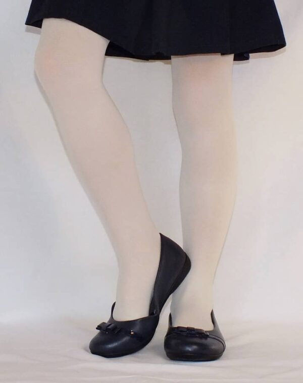 Person wearing skirt and black flats.