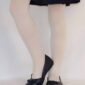 Person wearing skirt and black flats.