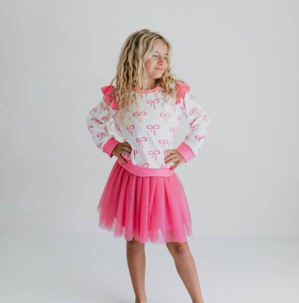 product Girl in pink outfit striking a pose.