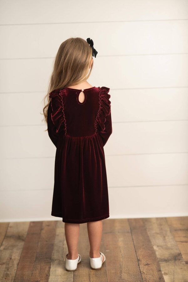 oopsie daisy kids burgundy wine velvet bow ruffle holiday party dress Child in red velvet dress facing away