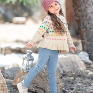 Child outdoors with lantern in autumn outfit