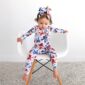 Toddler wearing patriotic star and butterfly outfit.