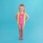Child in colorful swimsuit on blue background