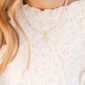 Pearl necklace with gold cross on lace dress.