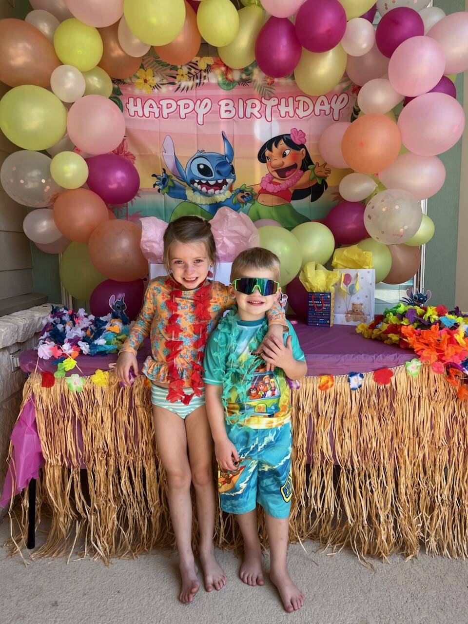 Kids at tropical-themed birthday party with decorations.